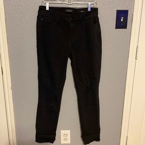 Judy Blue black distressed knee slim fit. Raw edge can be rolled.